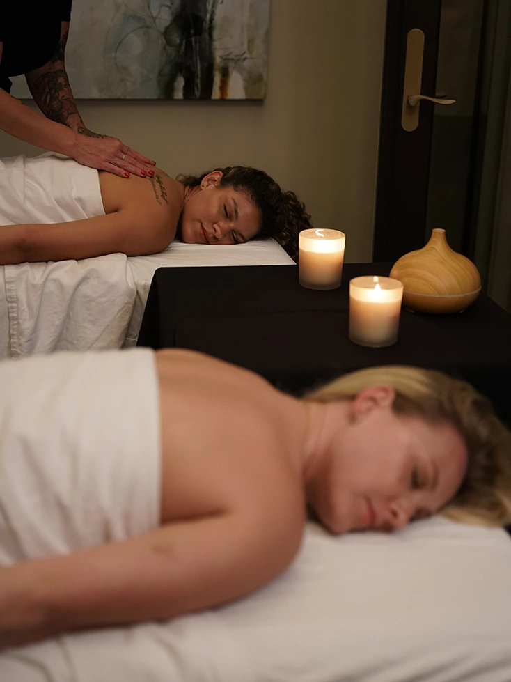 a woman lying on a table with a woman lying on it