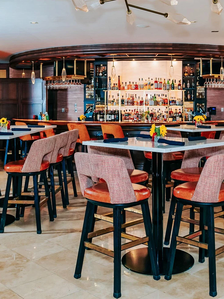 a bar with many tables and chairs