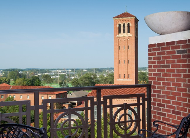 a balcony with a tower in the background