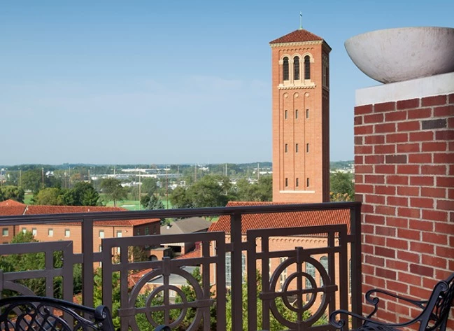 a balcony with a tower in the background