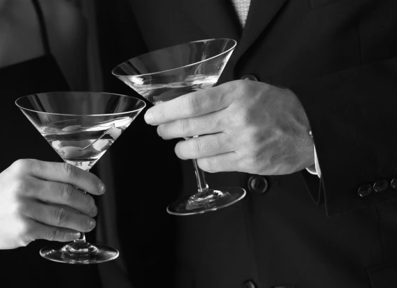 a man and woman holding martini glasses