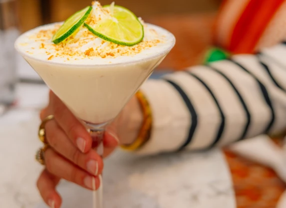 a hand holding a glass of food