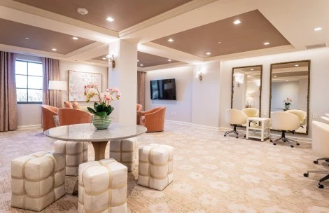 a room with a round table and chairs