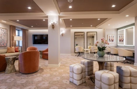 a room with a round table and chairs