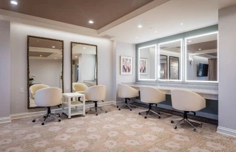 a room with a mirror and chairs