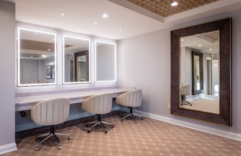 a room with a mirror and chairs