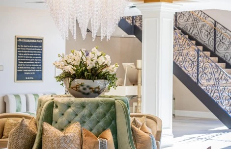 a room with a chandelier and couches