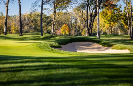 a golf course with a sand trap