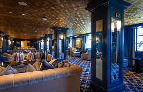 a room with a mirror and couches