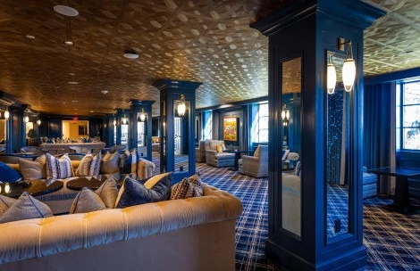 a room with a mirror and couches