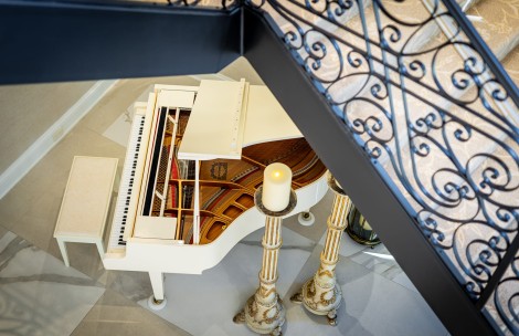 a white piano with a candle