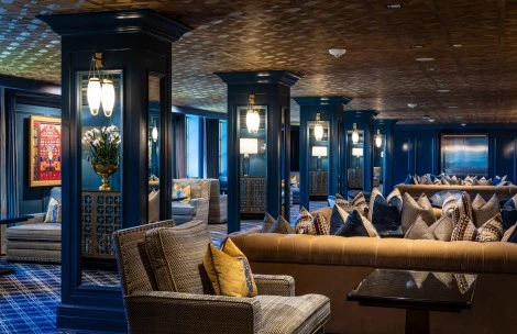 a room with a couch and chairs