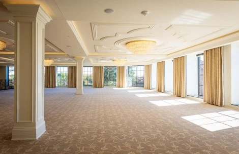 a large room with a chandelier and windows