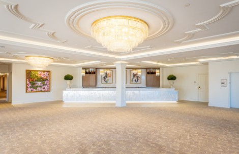 a large room with a chandelier and a white counter