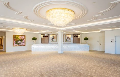 a large room with a chandelier and a white counter