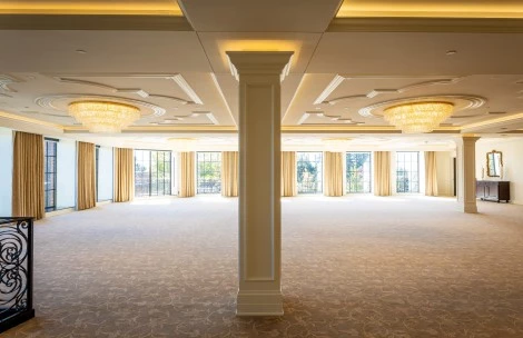 a large room with a large pillar and chandeliers