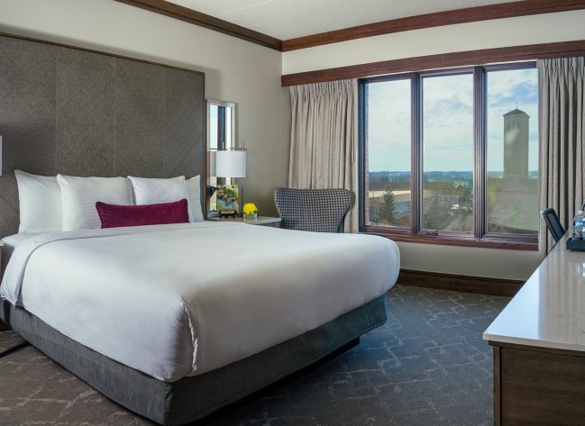 a hotel room with a bed and a window