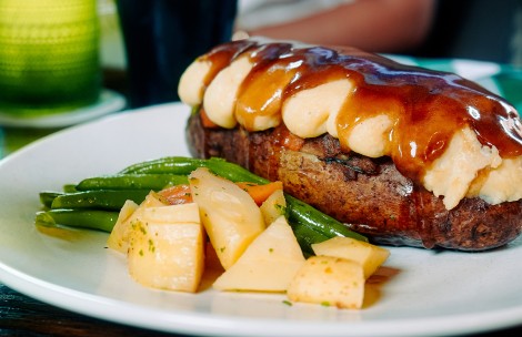 a plate of food with a side of potatoes and a meatloaf