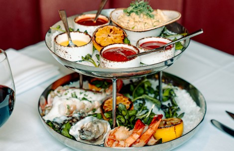 a tray of food with sauces and shrimp