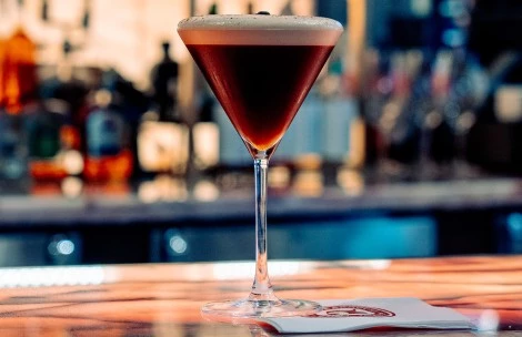 a glass of liquid on a table