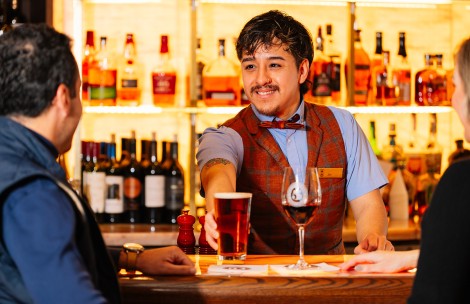 a man holding a glass of beer