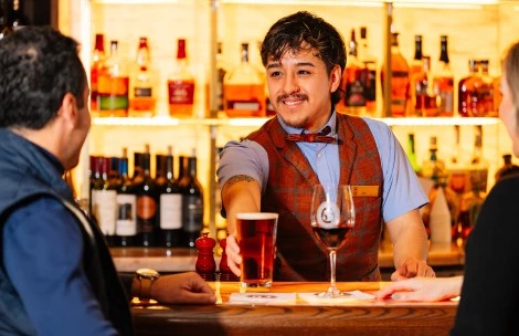 a man holding a glass of beer