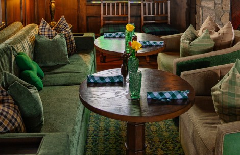 a table with green and white checkered napkins and glasses on it