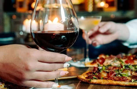 a hand holding a glass of wine