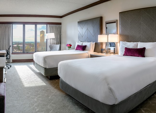 a room with two beds and a window