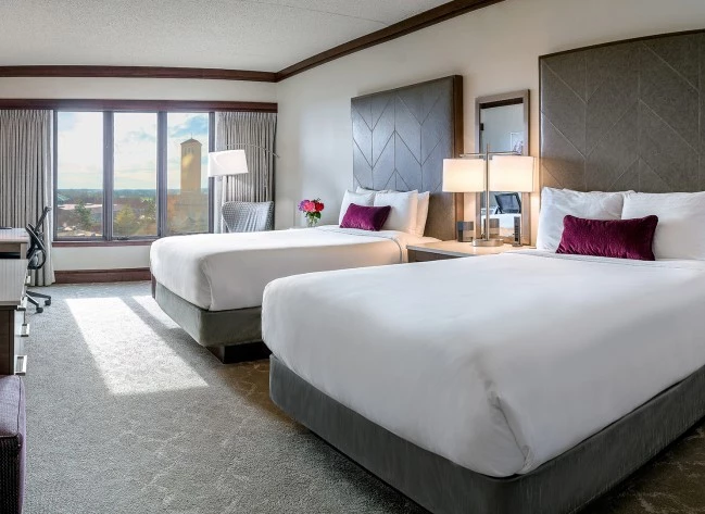 a room with two beds and a window