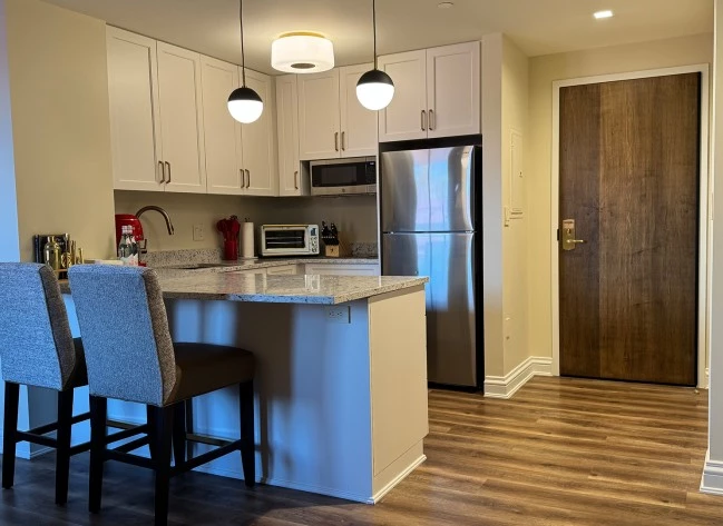 a kitchen with a bar and a refrigerator