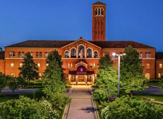 a building with a tower and trees