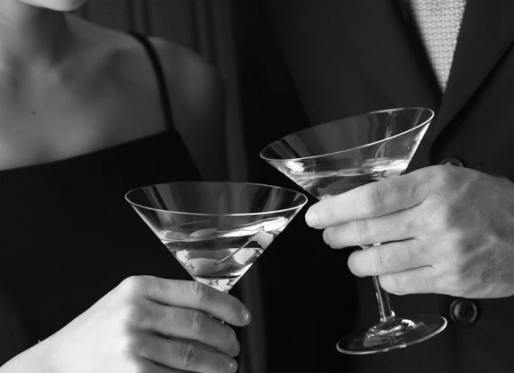 a man and woman holding martini glasses