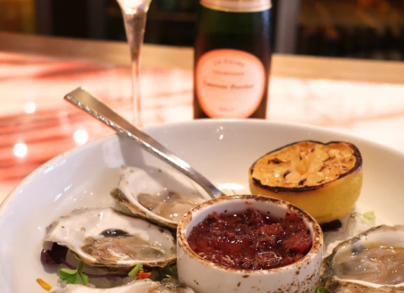 a plate of oysters and a lemon