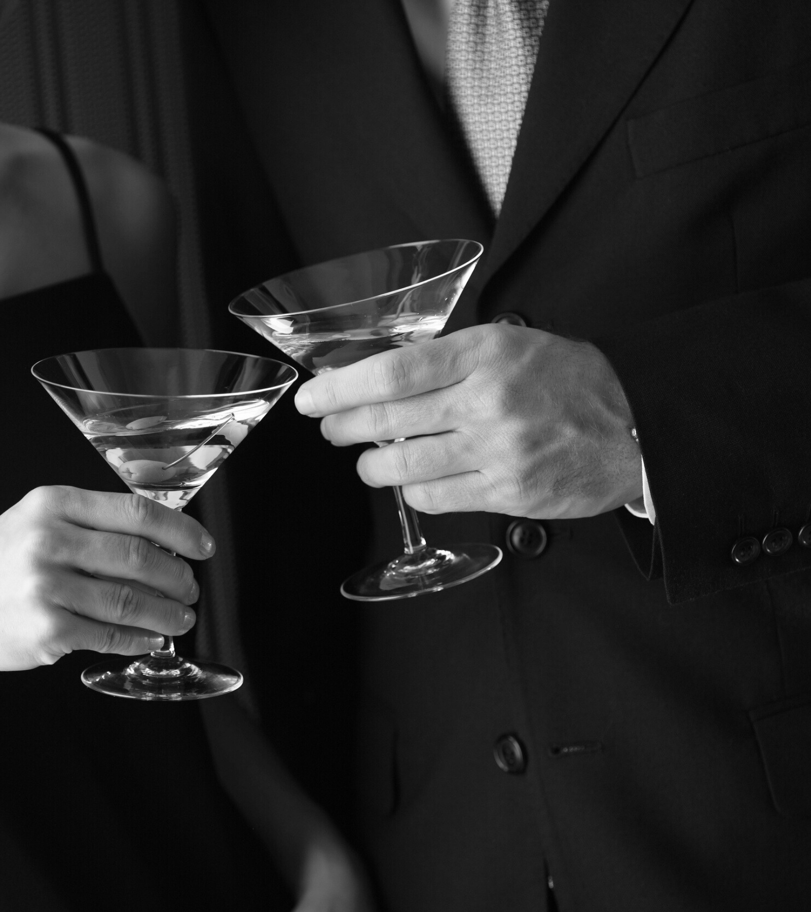 a man and woman holding martini glasses