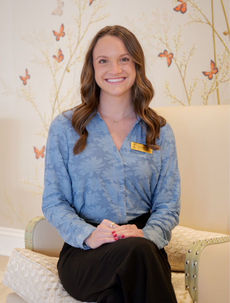 a woman sitting in a chair smiling