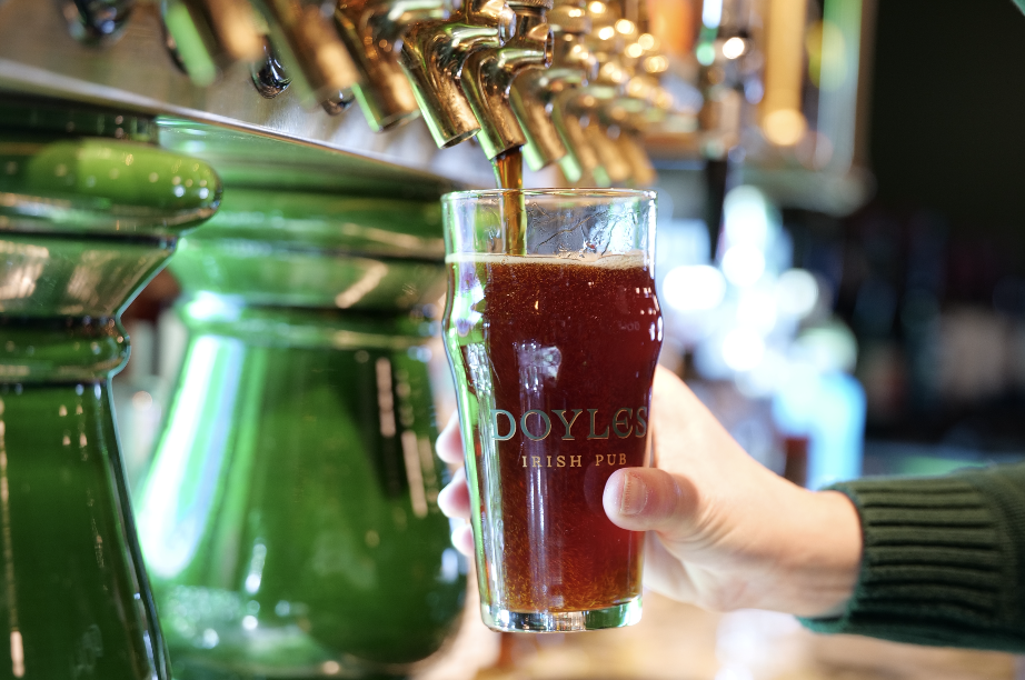 a person pouring a beer into a glass