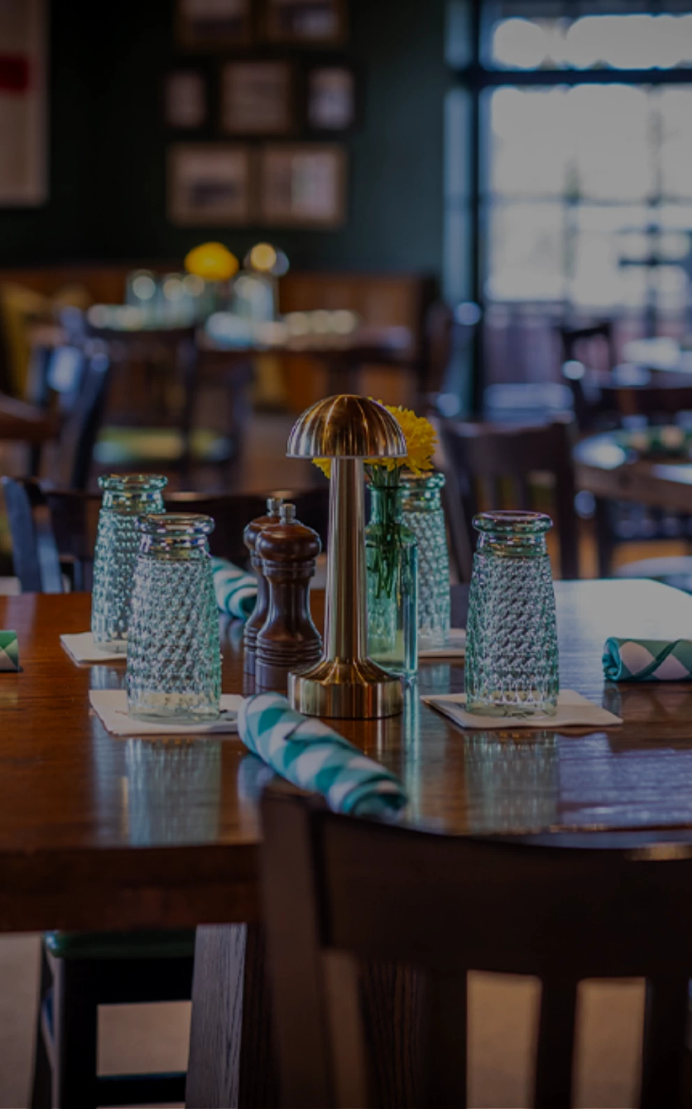 a table with a gold lamp and salt and pepper shakers