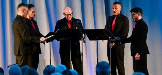 a group of men performing on stage