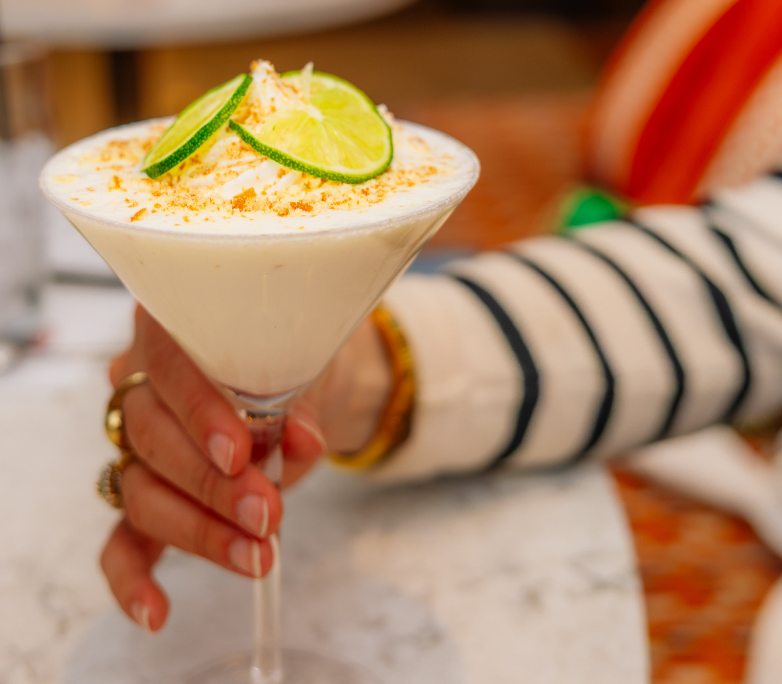 a hand holding a glass of food