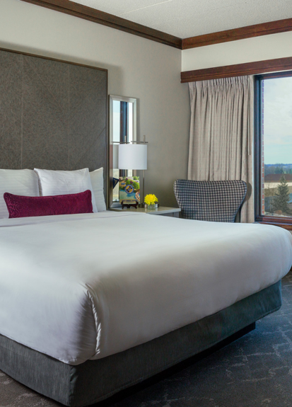 a bed with a lamp and a window