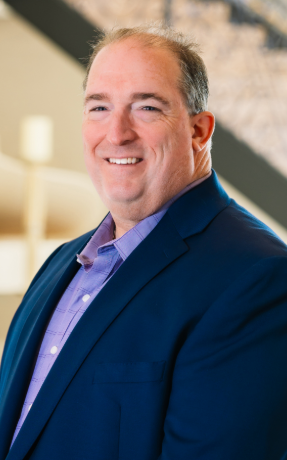 a man in a suit smiling