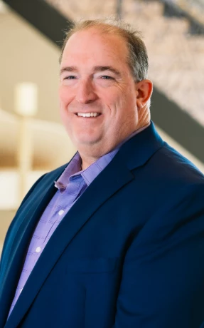 a man in a suit smiling