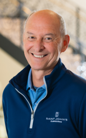 a man smiling at the camera