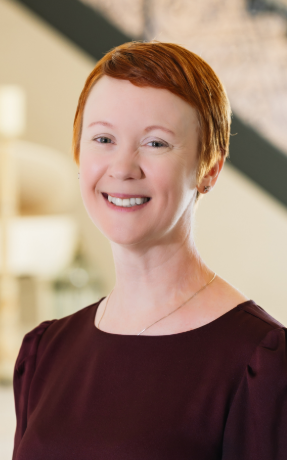 a woman with short red hair