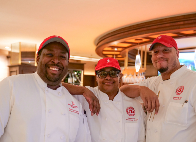 a group of men wearing red hats and white uniforms