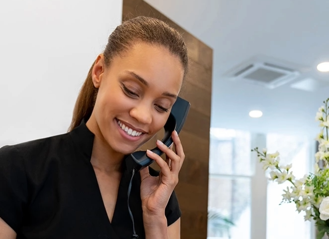 a woman holding a phone to her ear