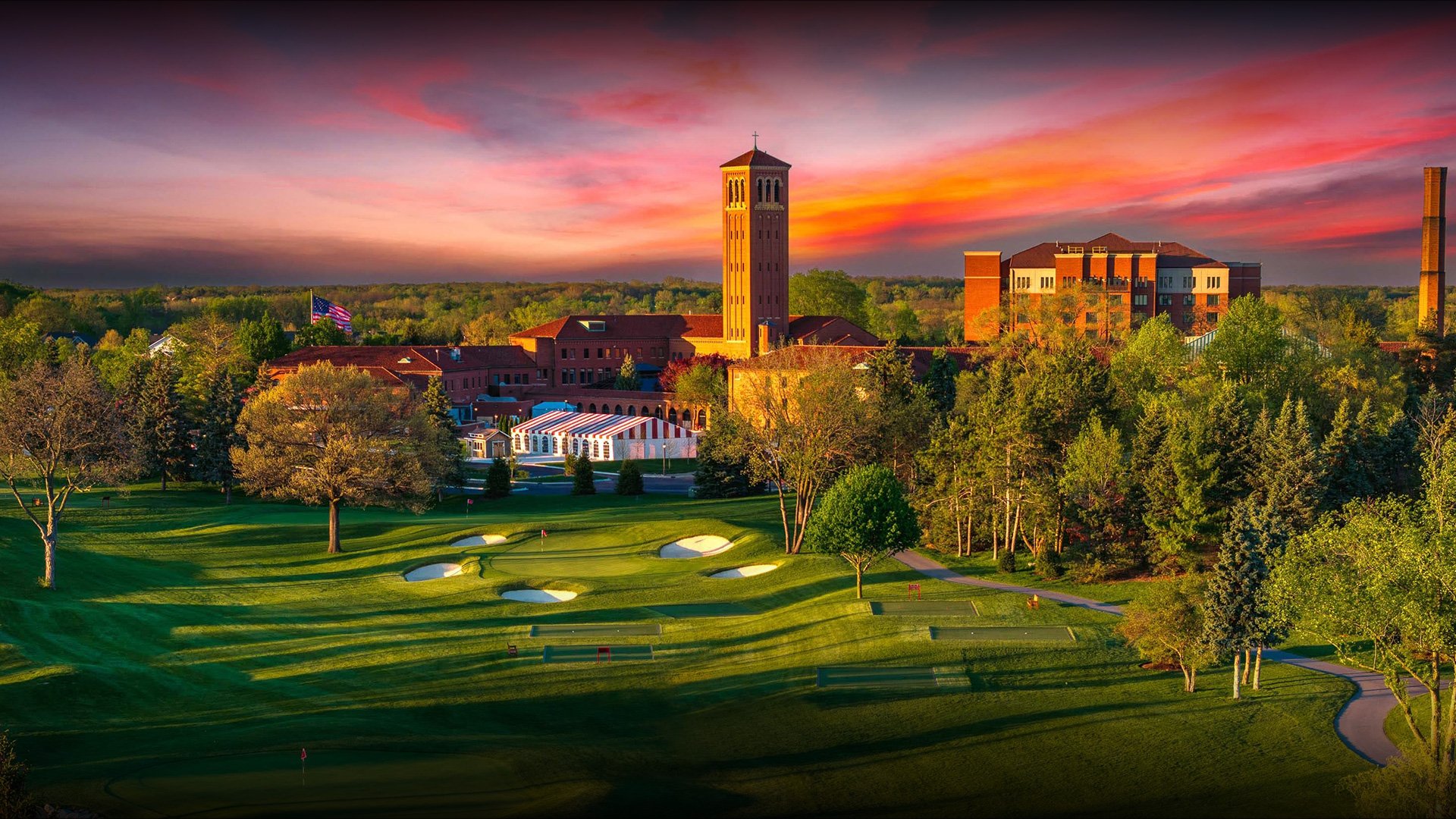 a golf course with a building and trees