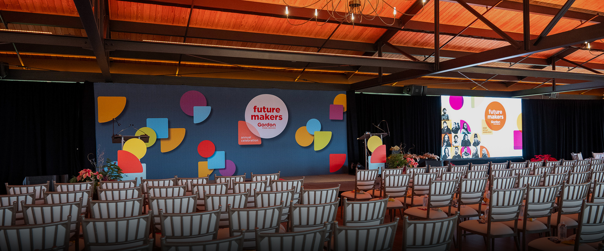 a stage with chairs and a podium