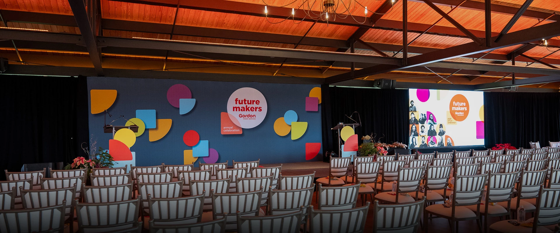 a stage with chairs and a podium